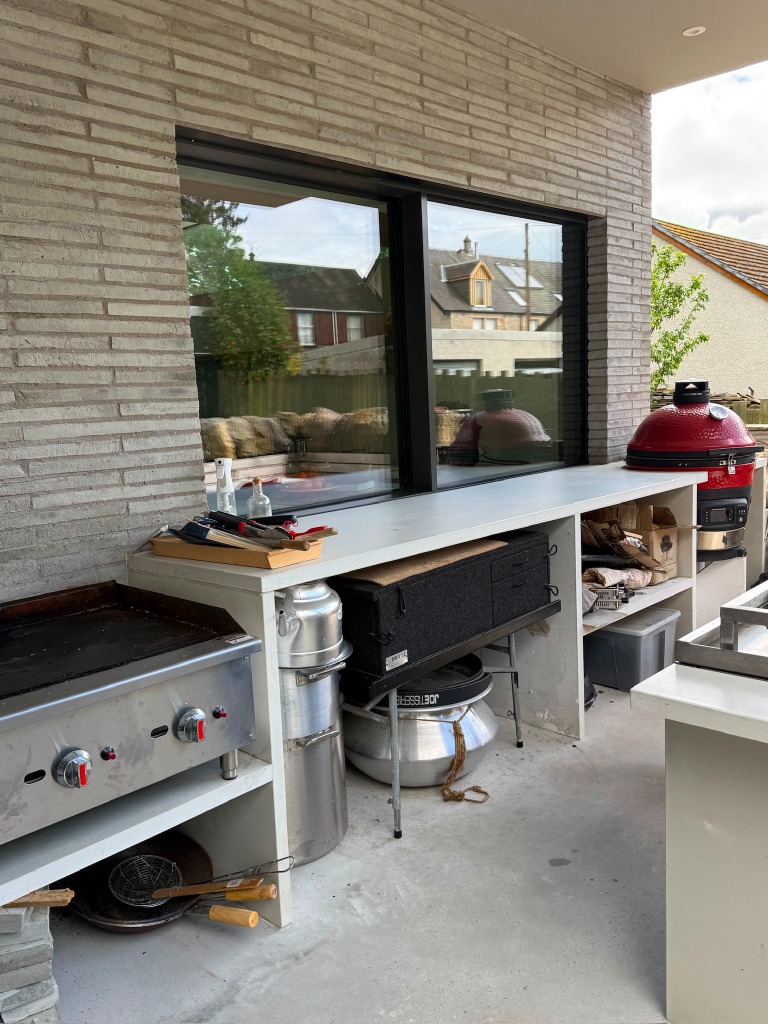 Outdoor kitchen with plancha grill and kamado